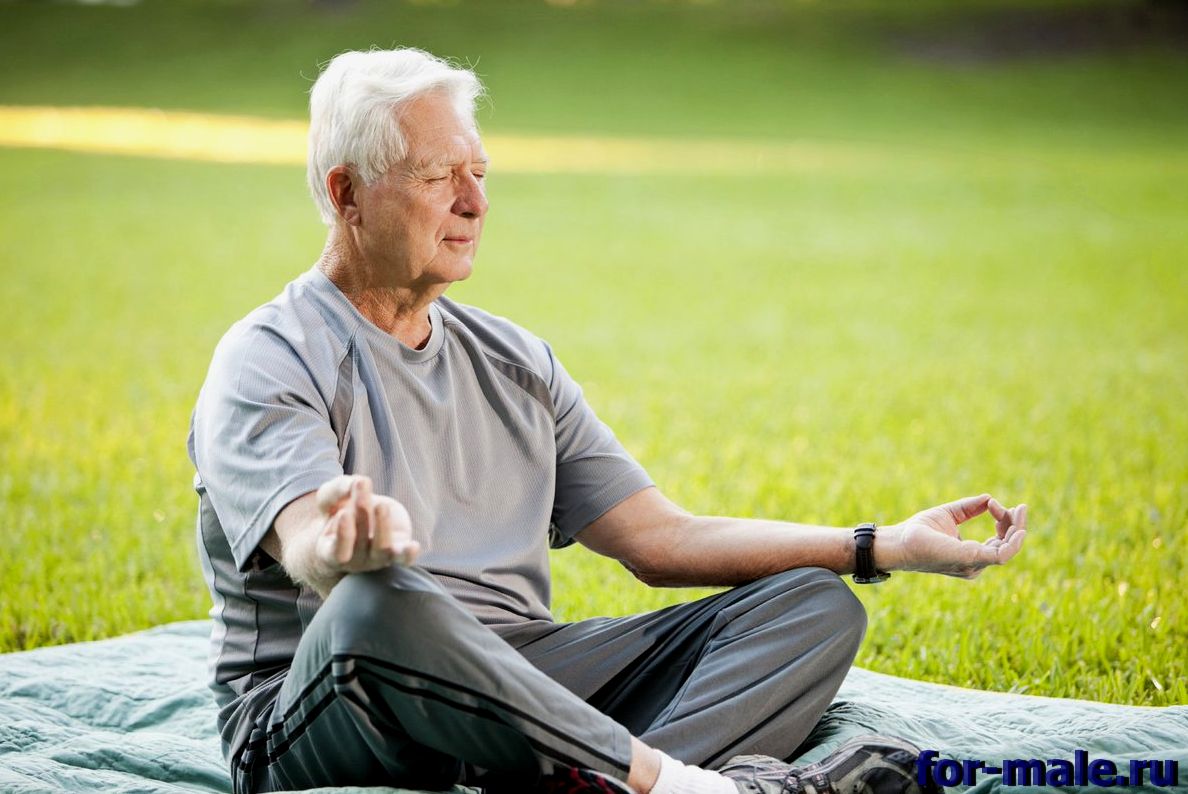 Мужчина в возрасте медитирует на улице